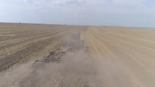 Aerial view of tractor plowing a field