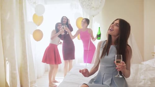 Happy Attractive Women Drinking Champagne at Hen Party