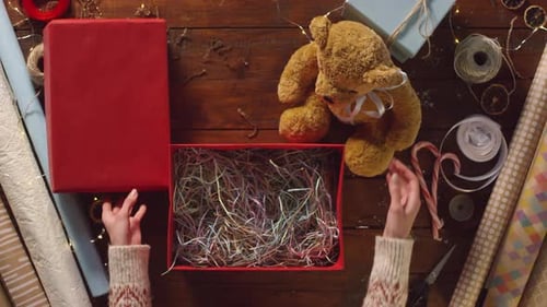 Gift Box Preparation with Stuffed Bear and Decorations