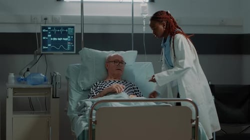 Doctor Installing Oximeter on Patient Hand in Hospital Ward
