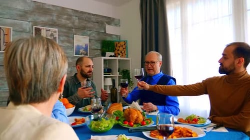 Adults Toasting with Wine at Cheerful Dinner Table