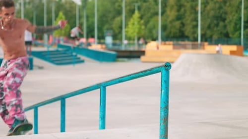 Skateboarder Grinds Rail at Skate Park