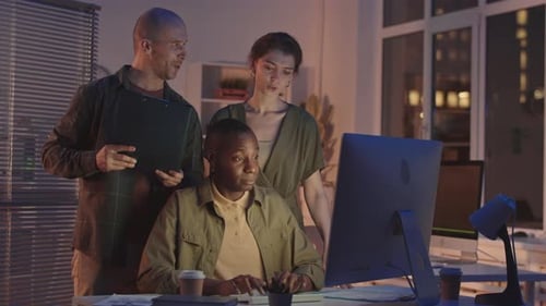 Team of Software Developers Working in Office at Night