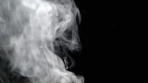 White Steam Rises on a Black Background