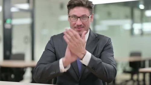 Happy Business Man Clapping Hands in Modern Office
