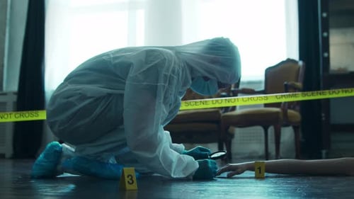 Forensic Investigator Examines Crime Scene Evidence