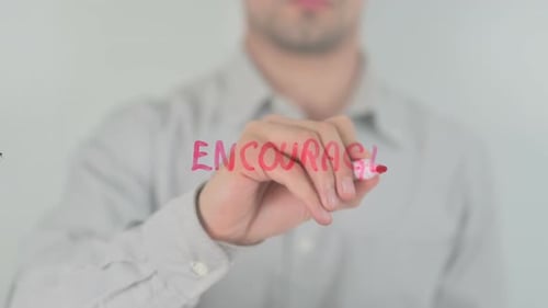 Man Writes Encourage with Pink Marker