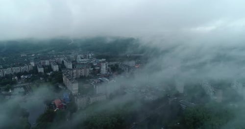 View from above of a city covered in fog