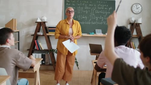 Teacher Lecturing Math to Students in Classroom