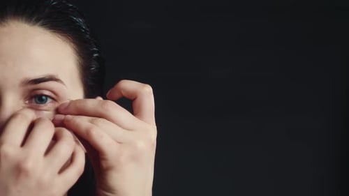 Woman Applying Moisturizing Eye Patches Close Up
