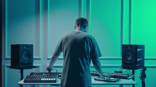 Music production studio. Producer. Man working in the recording studio with computer and mixer