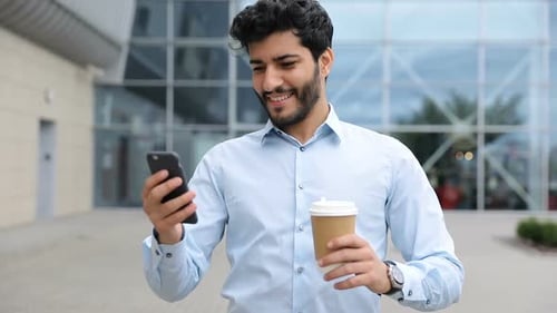 Handsome Business Man With Phone And Coffee On Street