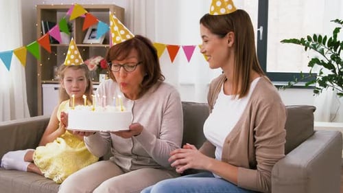 Family Celebrates Birthday with Cake and Candles