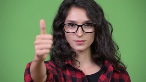 Woman Gives Thumbs Up on Green Background