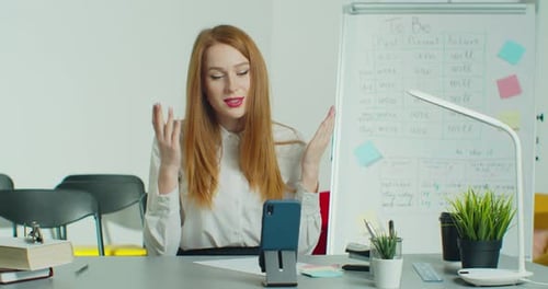Woman Leading an Online Class from her Desk
