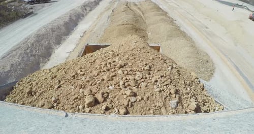 POV shot of a construction truck transporting gravel on a highway construction site