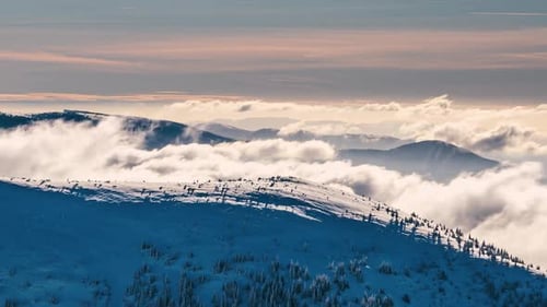 Snowy Mountains with Clouds at Golden Hour