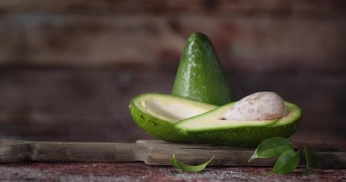 Avocados on Cutting Board Being Spritzed with Water