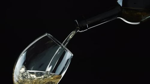 Pouring White Wine Into a Glass