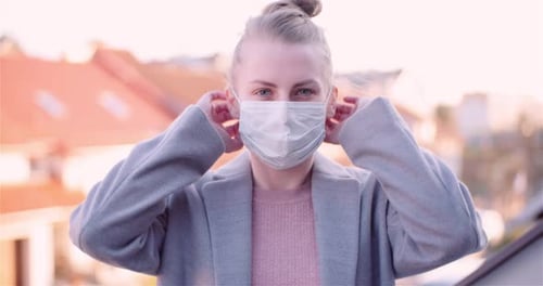 Woman Puts On Surgical Mask in City