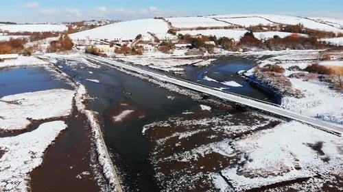 Aerial View of Snow-Covered Rural Landscape in Winter