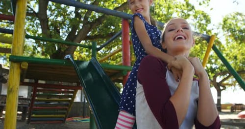 Mother and daughter playing in the playground 4k