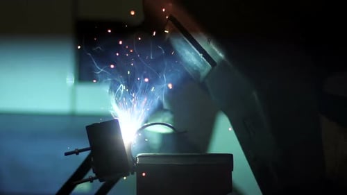 Welder Creates Sparks in Industrial Metalworking Process