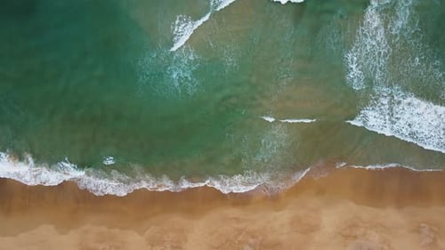 Aerial view of white sand beach and ocean wave