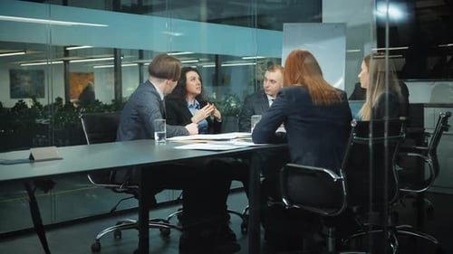 Team Brainstorming in Modern Glass Office