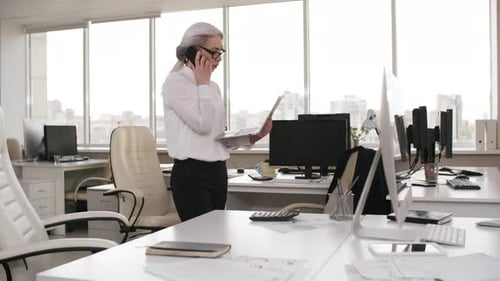 Middle-Aged Caucasian Lawyer Talking on Phone in Empty Office