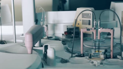 Work of the Biochemical Analyzer in the Laboratory Close Up. Test Tubes That Are Automatically Sent