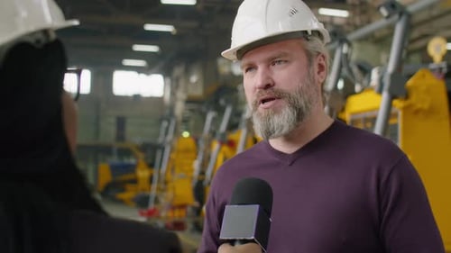 Senior Factory Engineer Giving Interview to TV Journalist