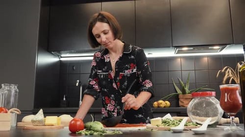 Woman Making Homemade Pizza in Modern Kitchen