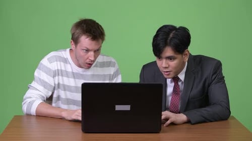 Men React with Surprise to Laptop Computer