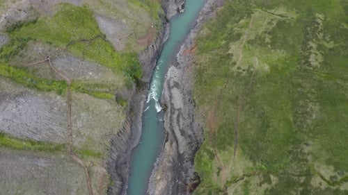 Aerial Shot Of Stream In Basalt Rock Columns In Studlagil Canyon, Eastern Iceland.