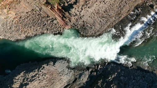Overhead View Rough Glacier Water Flowing in Stuolagil Canyon with Basalt Volcanic Rock Formations