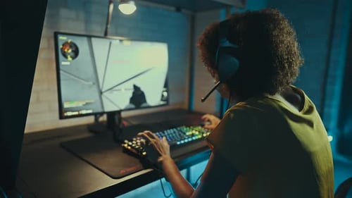 Person Playing Video Game on Computer Indoors