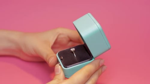 Hands Reveal Diamond Ring in Blue Box