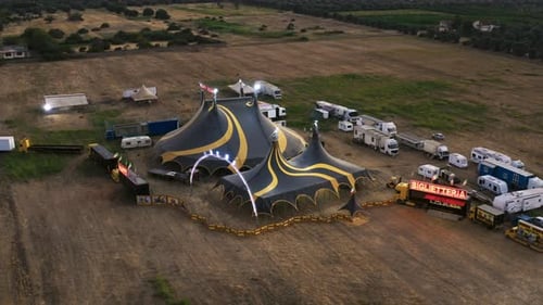 Big Top of a Circus with Caravans in a Field