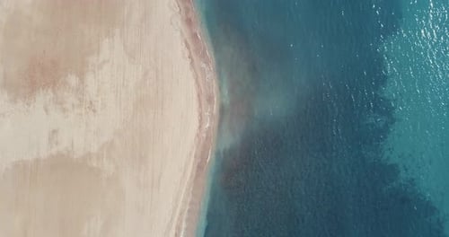 Sea waves washing sandy shore
