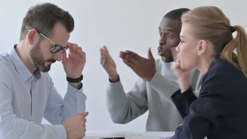 Business People Scolding Businessman in Office