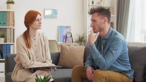 Man Discussing Problems with Counselor in Bright Office