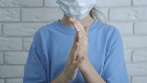 Child Applying Hand Sanitizer in Close Up Shot