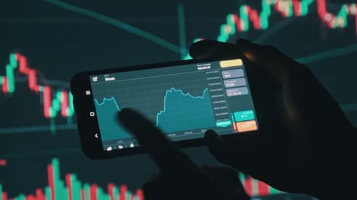 investor checking bitcoin charts on phone