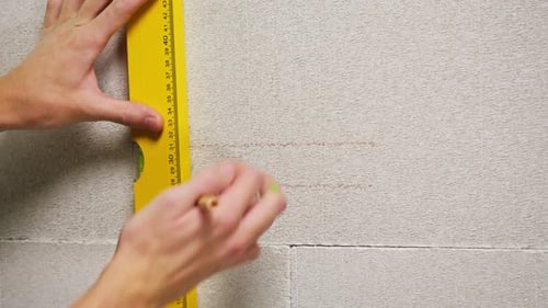 Man Builder Using Balance Ruler and Drawing Line Closeup