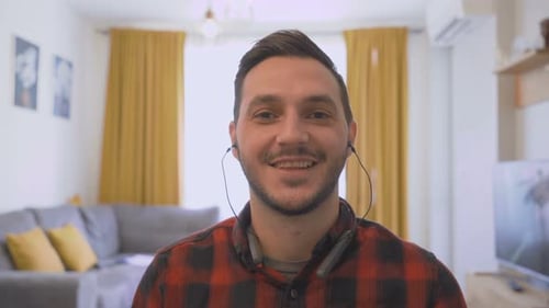 Man Smiling at Camera in Home Setting