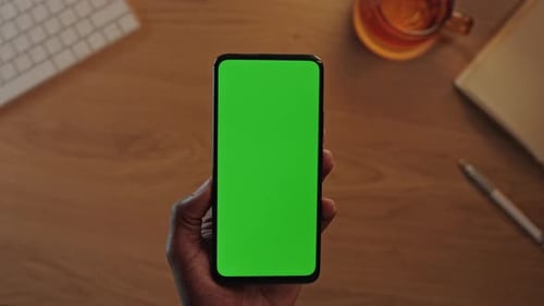 Black Male Hands Holding Vertical Mobile with Green Screen