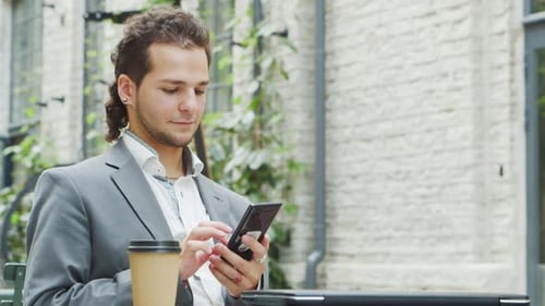 Man Using Mobile Phone in an Urban Setting