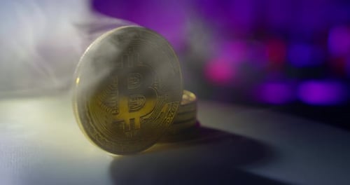 the Bitcoin Coin Rotates, Along in the Smoke. Close Up