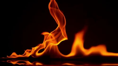 Bright Orange Flames Ripple Against Black Background